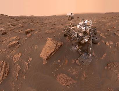 Description: Description: Description: A self-portrait by NASA's Curiosity rover taken on Sol 2082 (June 15, 2018). A Martian dust storm has reduced sunlight and visibility at the rover's location in Gale Crater. A drill hole can be seen in the rock to the left of the rover at a target site called "Duluth."